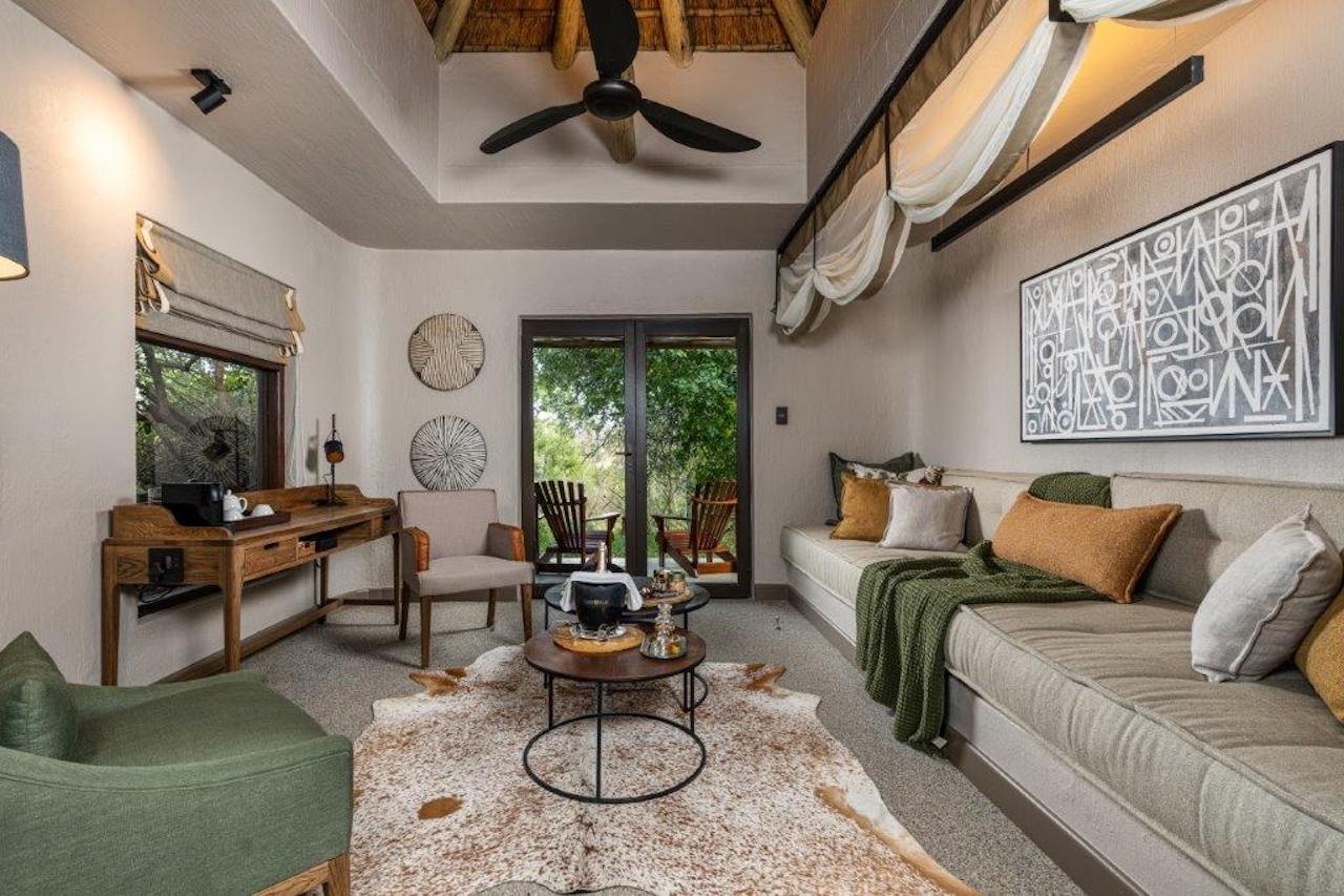 <p>The Suites at Sabi Sabi Bush Lodge are spacious and beautifully decorated with African-inspired furnishings and decor. Each room is equipped with modern amenities, including air conditioning, ceiling fans, and en-suite bathrooms with both indoor and outdoor showers.</p>  <p>The rooms also feature private decks with stunning views of the surrounding bushveld, providing guests with the opportunity to spot wildlife from the comfort of their own room.</p>  <p>Overall, the bedrooms at Sabi Sabi Bush Lodge offer a luxurious and unforgettable safari experience.</p>